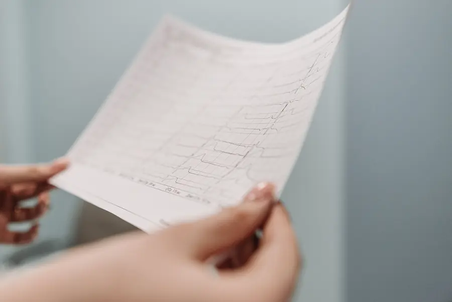 Hands holding a printed medical test report